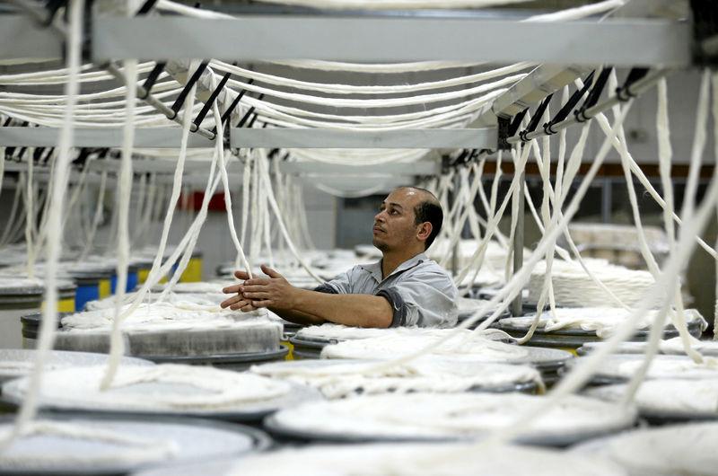 A factory worker works at a spinning factory on the outskirts of Cairo, Egypt